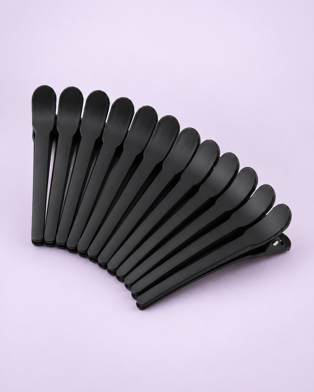 Twelve matte black duckbill sectioning clips fanned out
