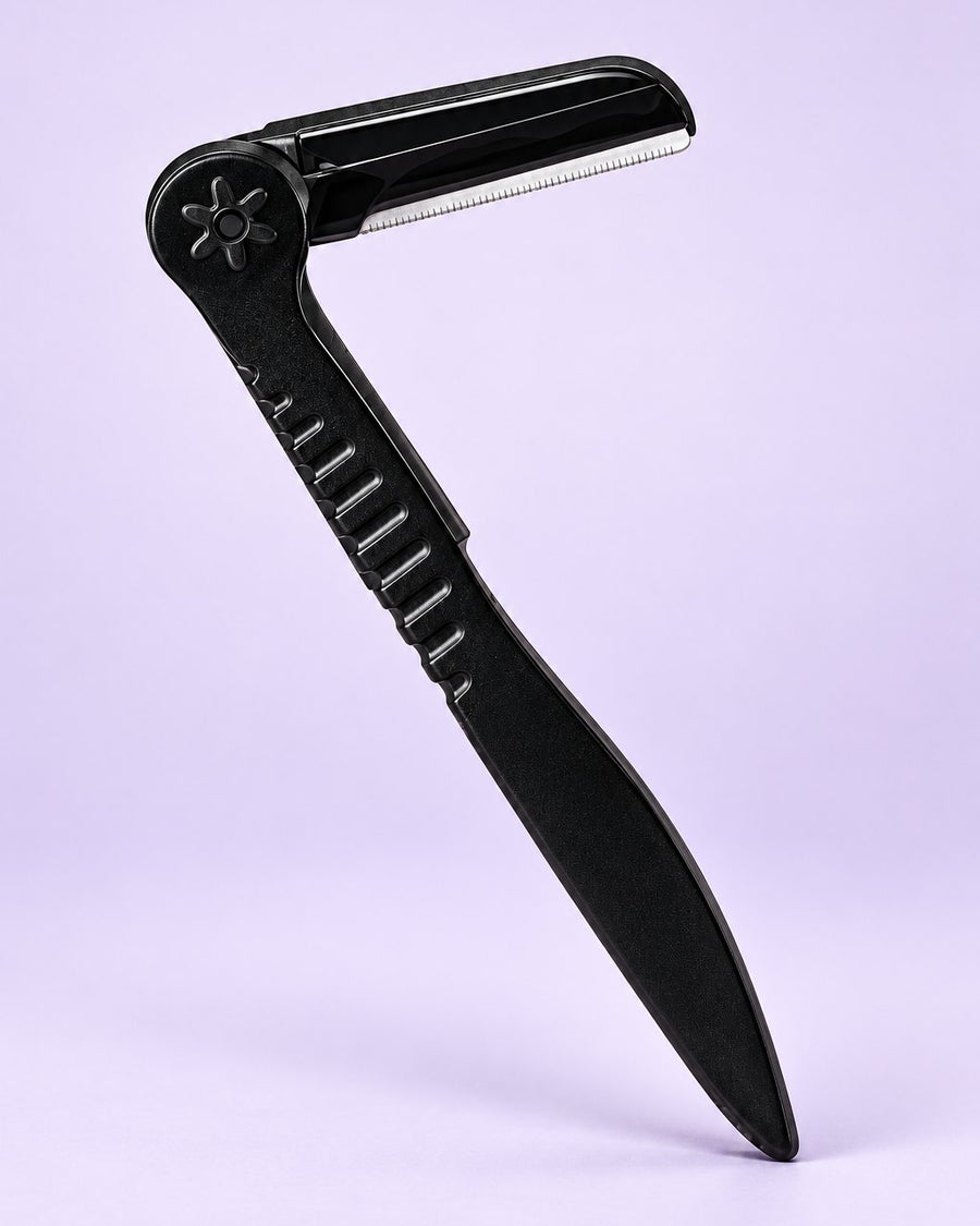 Black folding brow razor shown open