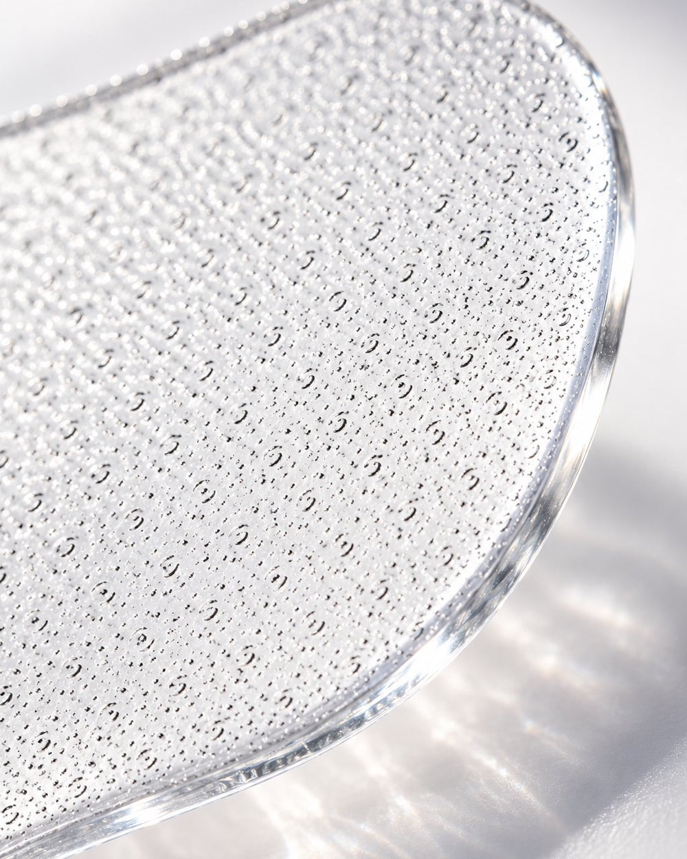 Macro close-up of the fine etched glass surface and polished edge