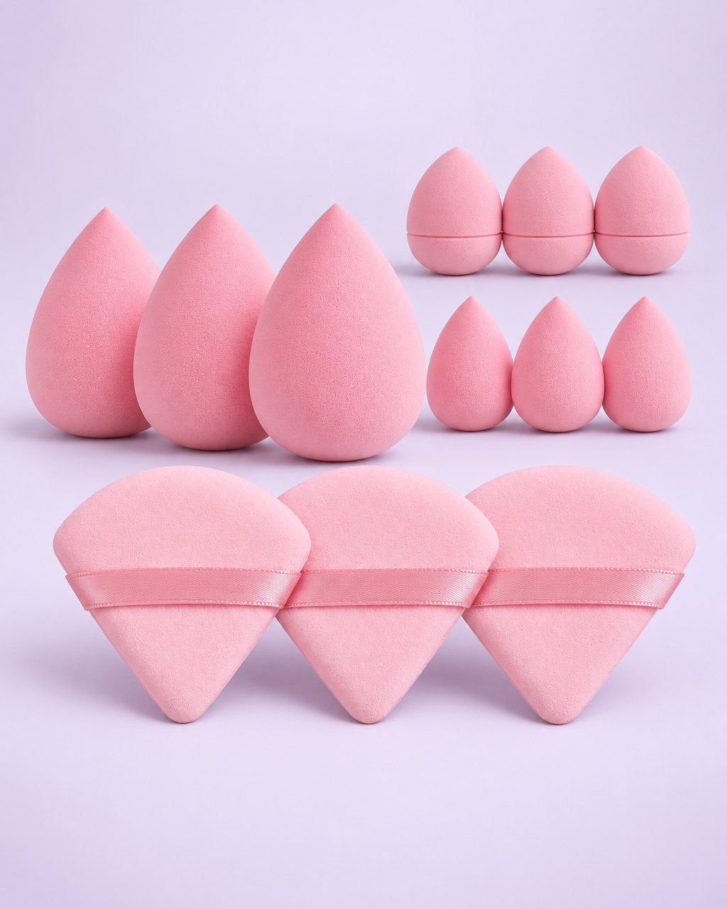 Pink set of twelve makeup sponges and triangle powder puffs laid out