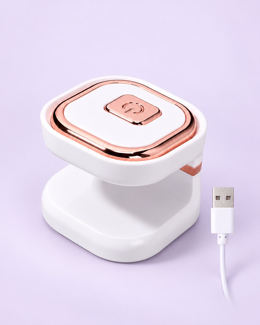 White mini one-finger UV LED nail lamp with rose-gold-tone trim and USB cable