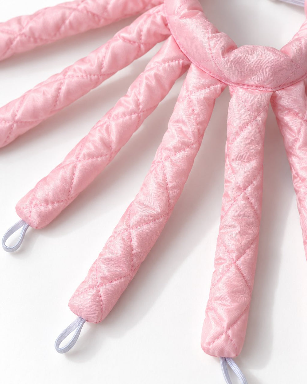 Close-up of the curler's padded fabric arms and the loop at each end