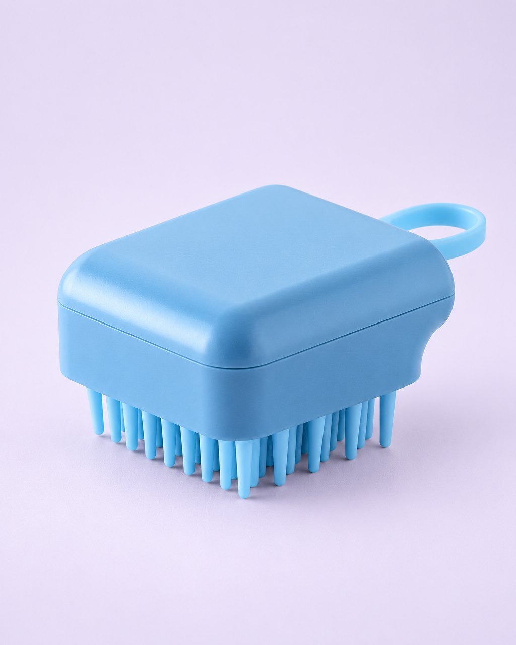 Blue palm-sized scalp shampoo brush with soft silicone bristles and a side loop