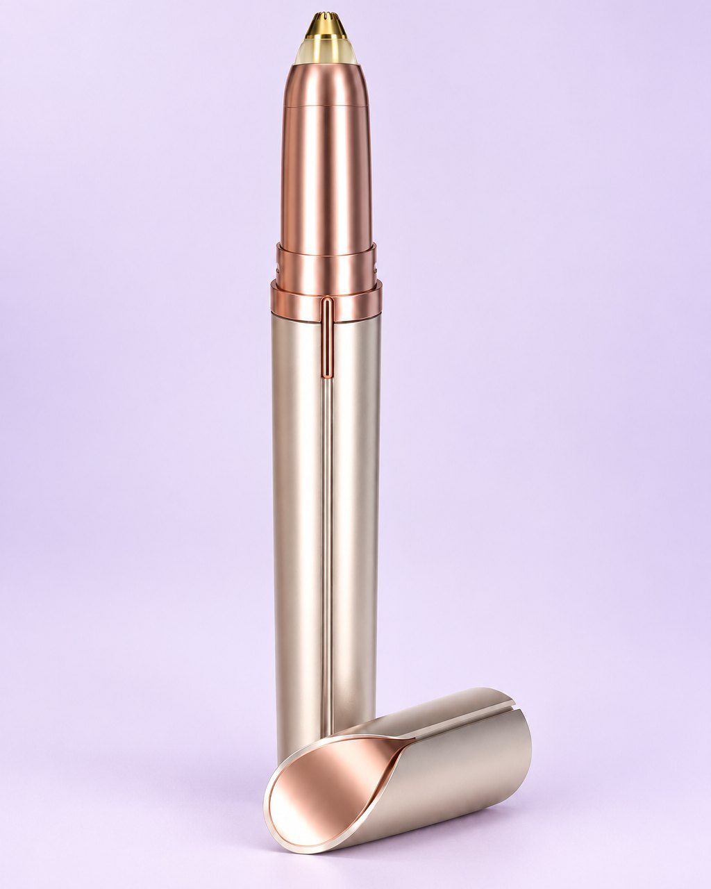 Rose-gold electric brow trimmer with its cap beside it