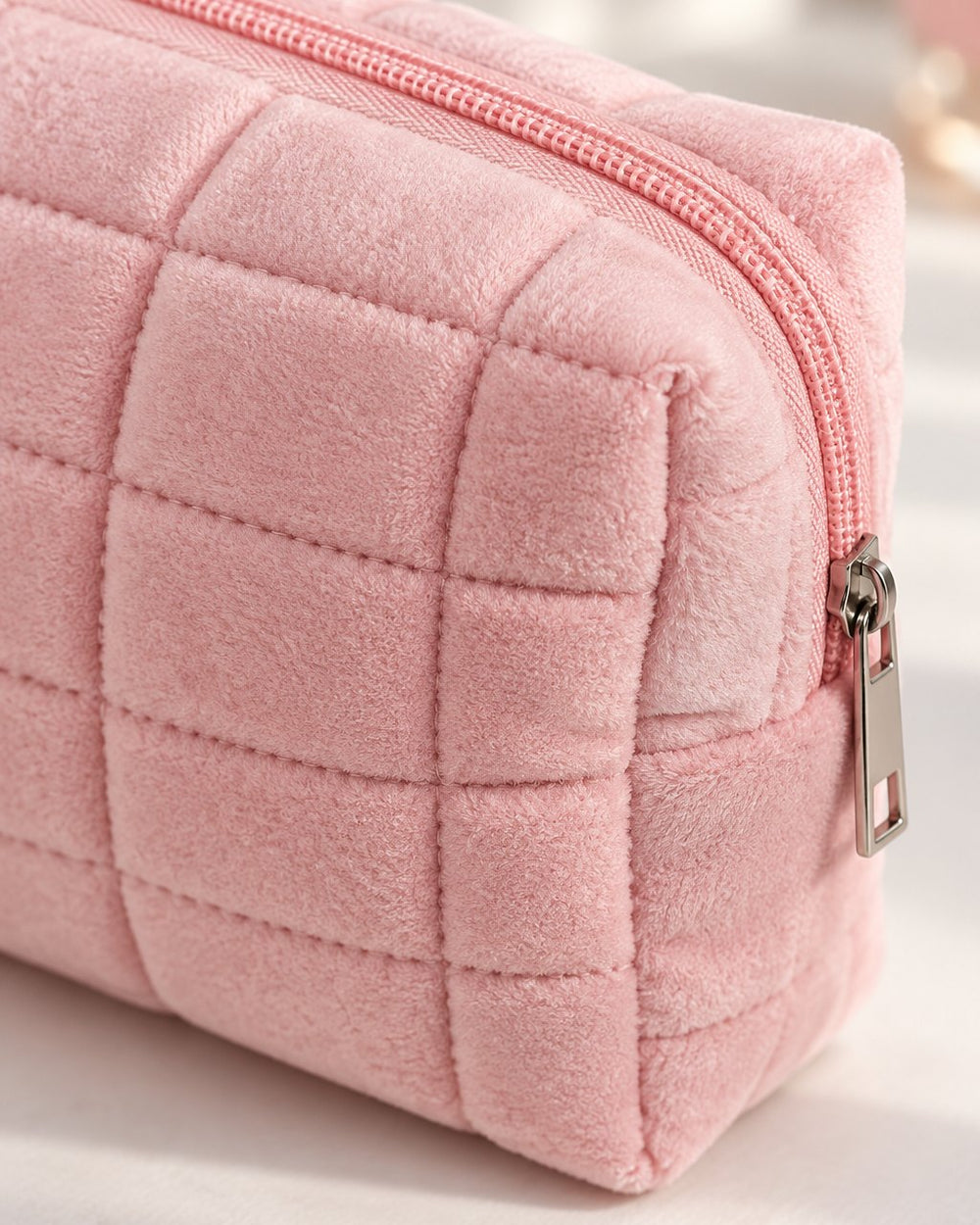 Close-up of the soft quilted squares and the matching zip