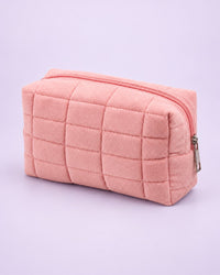Pink puffy quilted makeup bag with a zip
