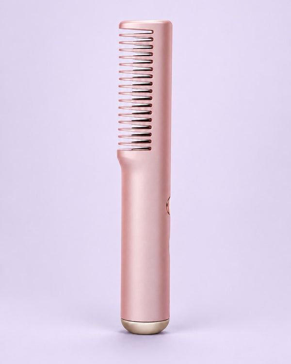 Pink cordless straightening comb with its single row of heated teeth