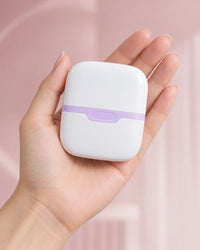 The capped double ice roller resting in an open palm