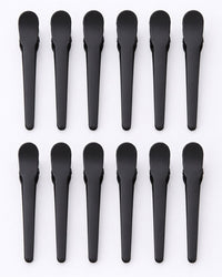 All twelve black clips laid out in a neat row