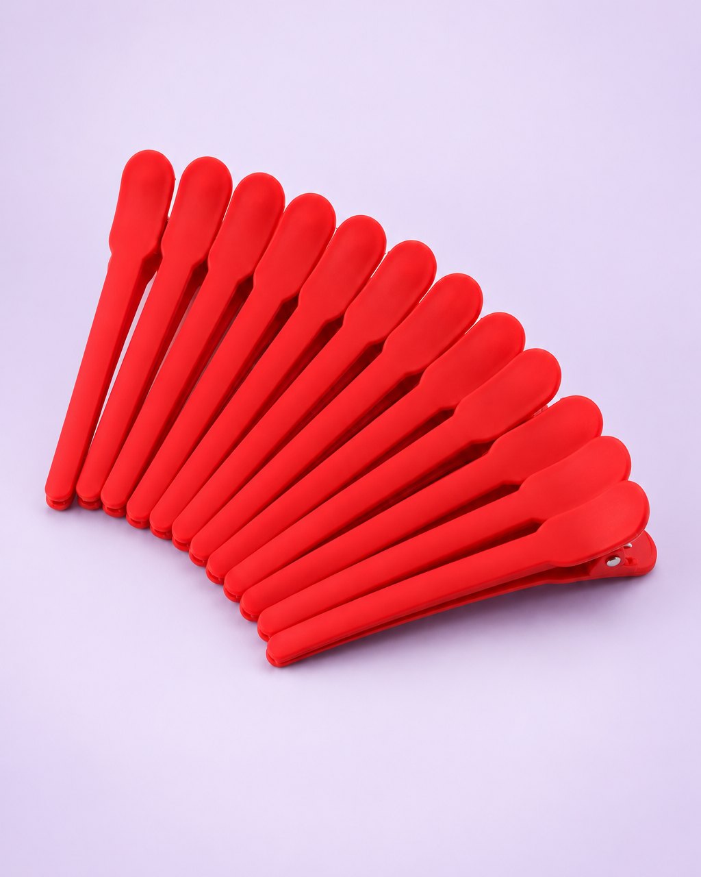 Twelve matte red duckbill sectioning clips fanned out