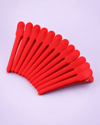 Twelve matte red duckbill sectioning clips fanned out