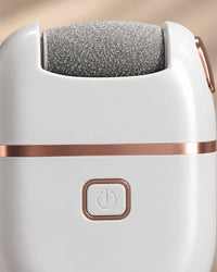 Close-up of the grey quartz sanding roller and the power button