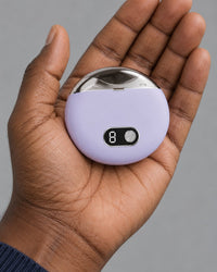 The palm-sized lilac nail clipper resting in one hand