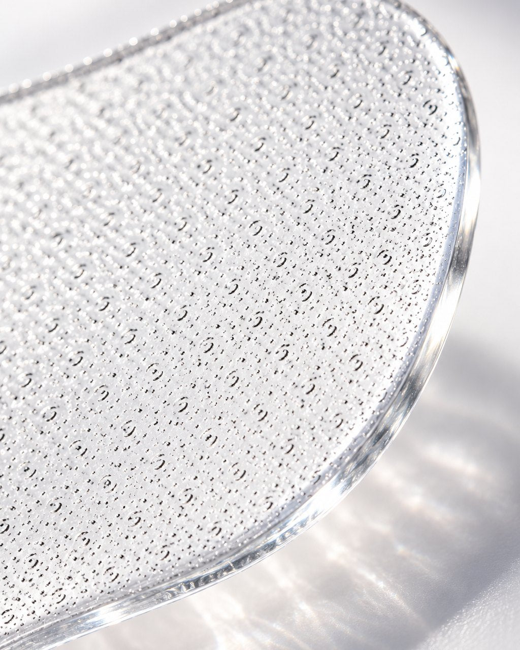 Macro close-up of the fine etched glass surface and polished edge