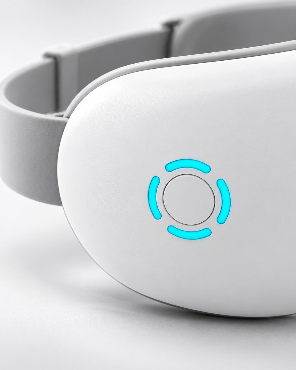 Close-up of the massager's round blue-lit power button on the white shell