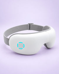 White heated eye massager with a grey head strap
