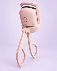 Pink heated lash curler with scissor handles