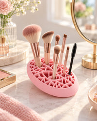 Pink holder on a vanity with brushes standing upright in the lid