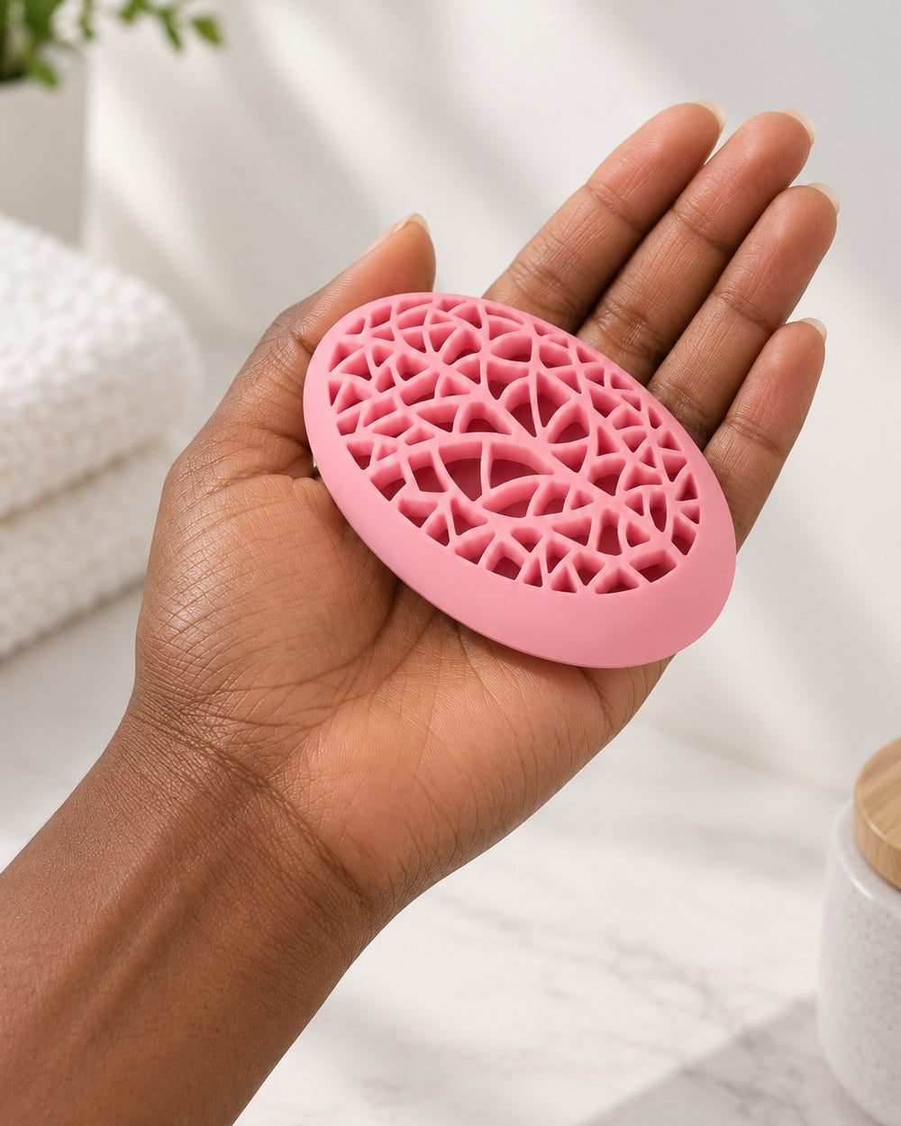The pink holder resting in one hand