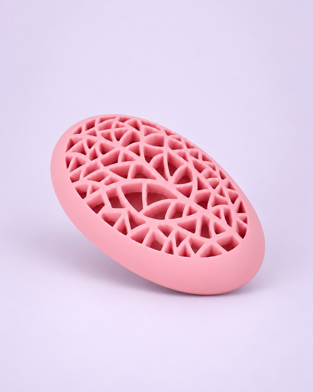 Pink egg-shaped silicone brush holder with a lattice lid