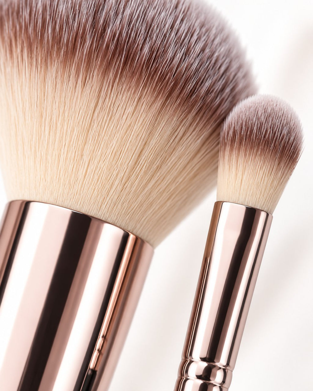 Close-up of a fluffy face brush and a small eye brush