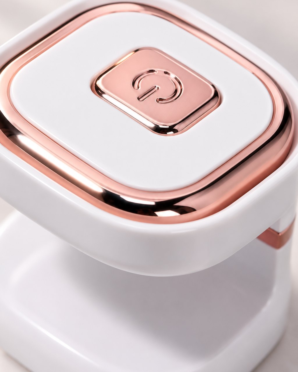 Close-up of the lamp's single button and rose-gold-tone trim