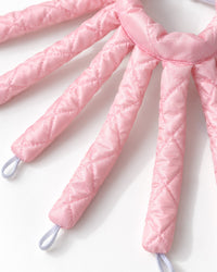Close-up of the curler's padded fabric arms and the loop at each end
