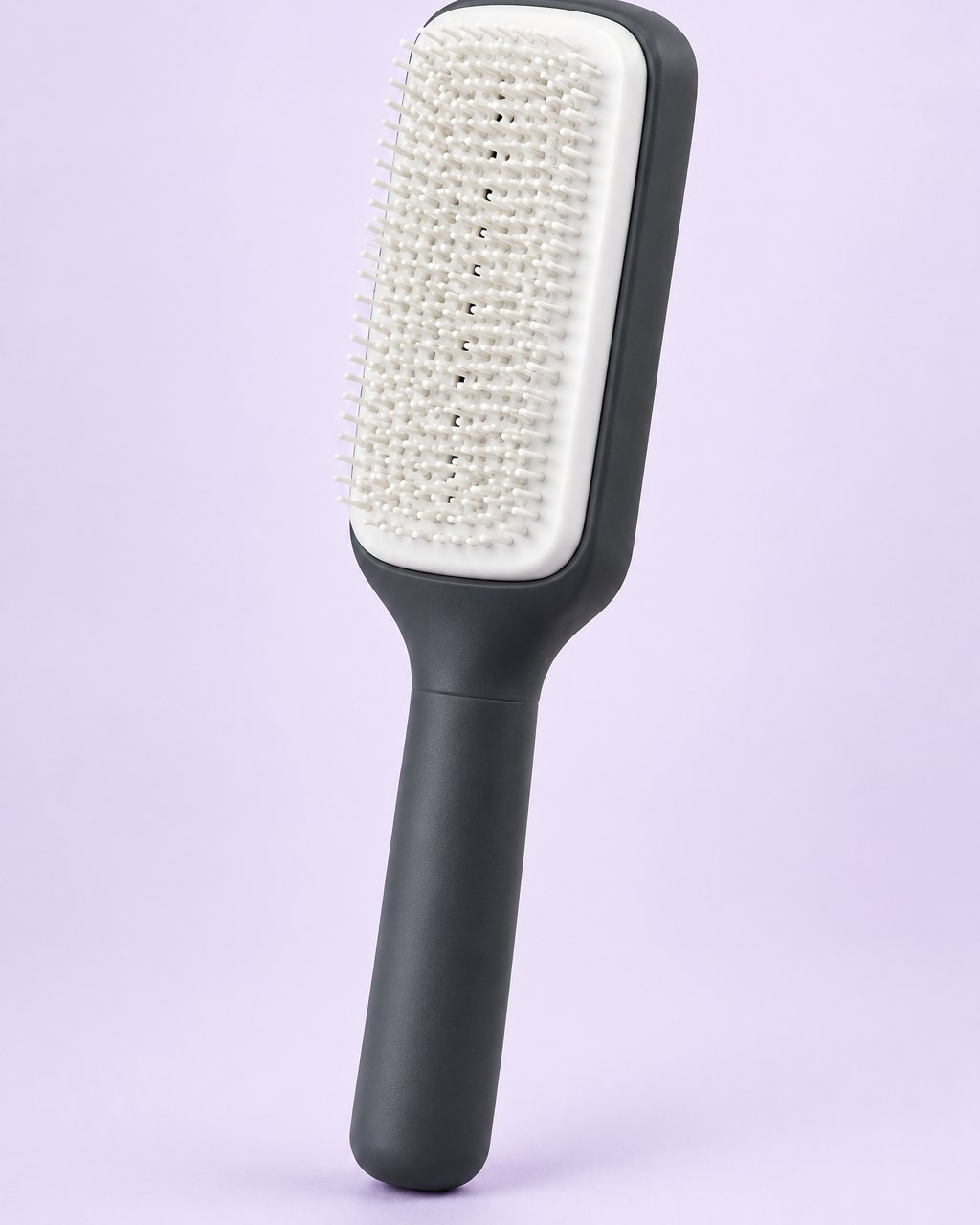 Charcoal self-cleaning paddle brush with a white cushioned pad