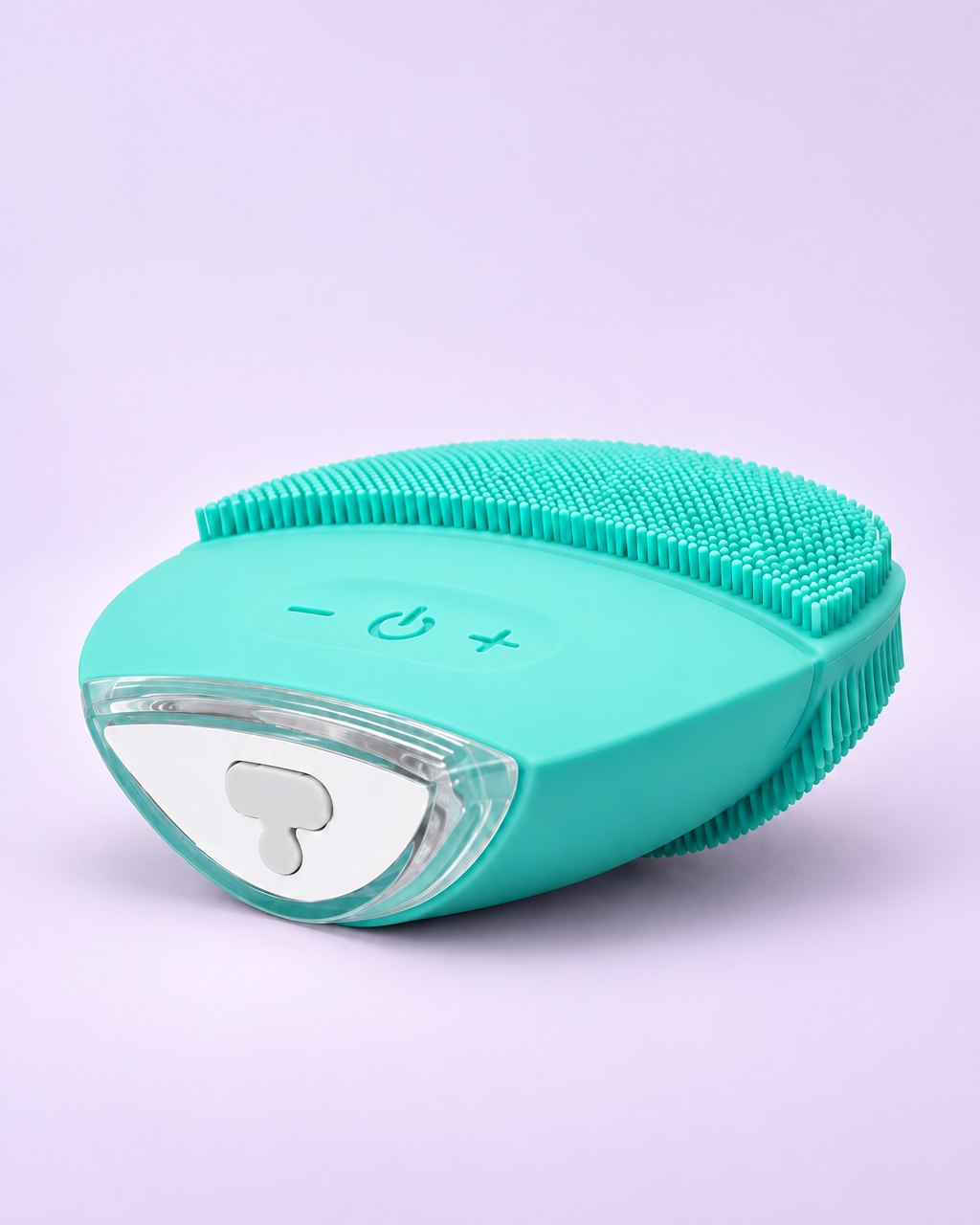 Mint green silicone face brush with soft nubs and three buttons