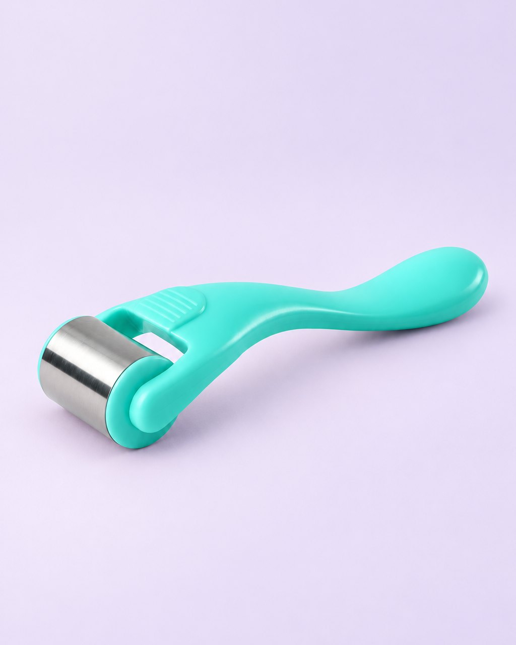 Mint green ice roller with a stainless steel roller head